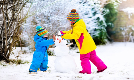 two-kids-playing-in-the-snow